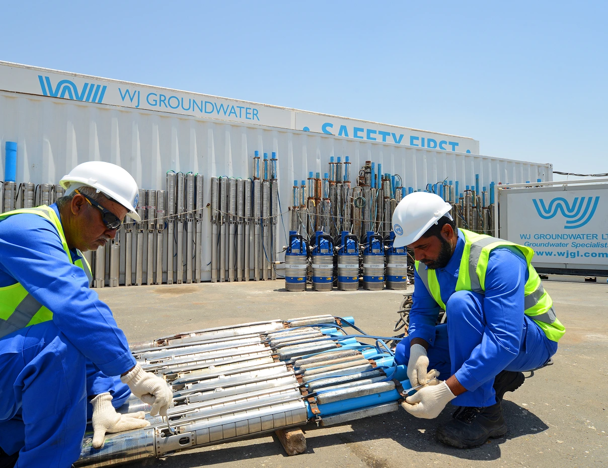 WJ Middle East 16 WJ Groundwater technicians inspecting groundwater equipment at a construction site.