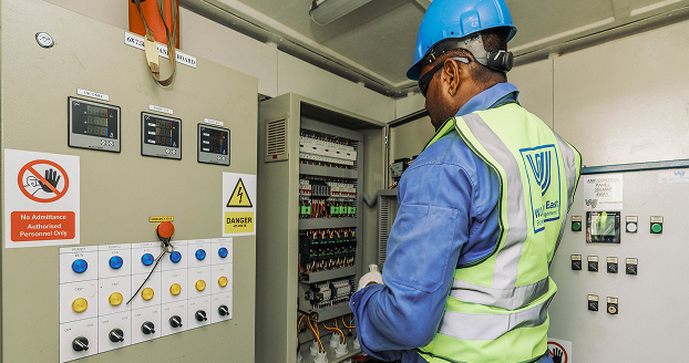 WJ Technician inspecting control panel.